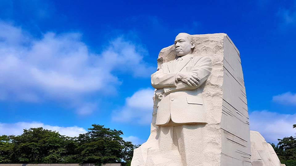 The 30-foot, granite Dr. Martin Luther King, Jr. Memorial statue in Washington, D.C. stands proudly against a blue sky